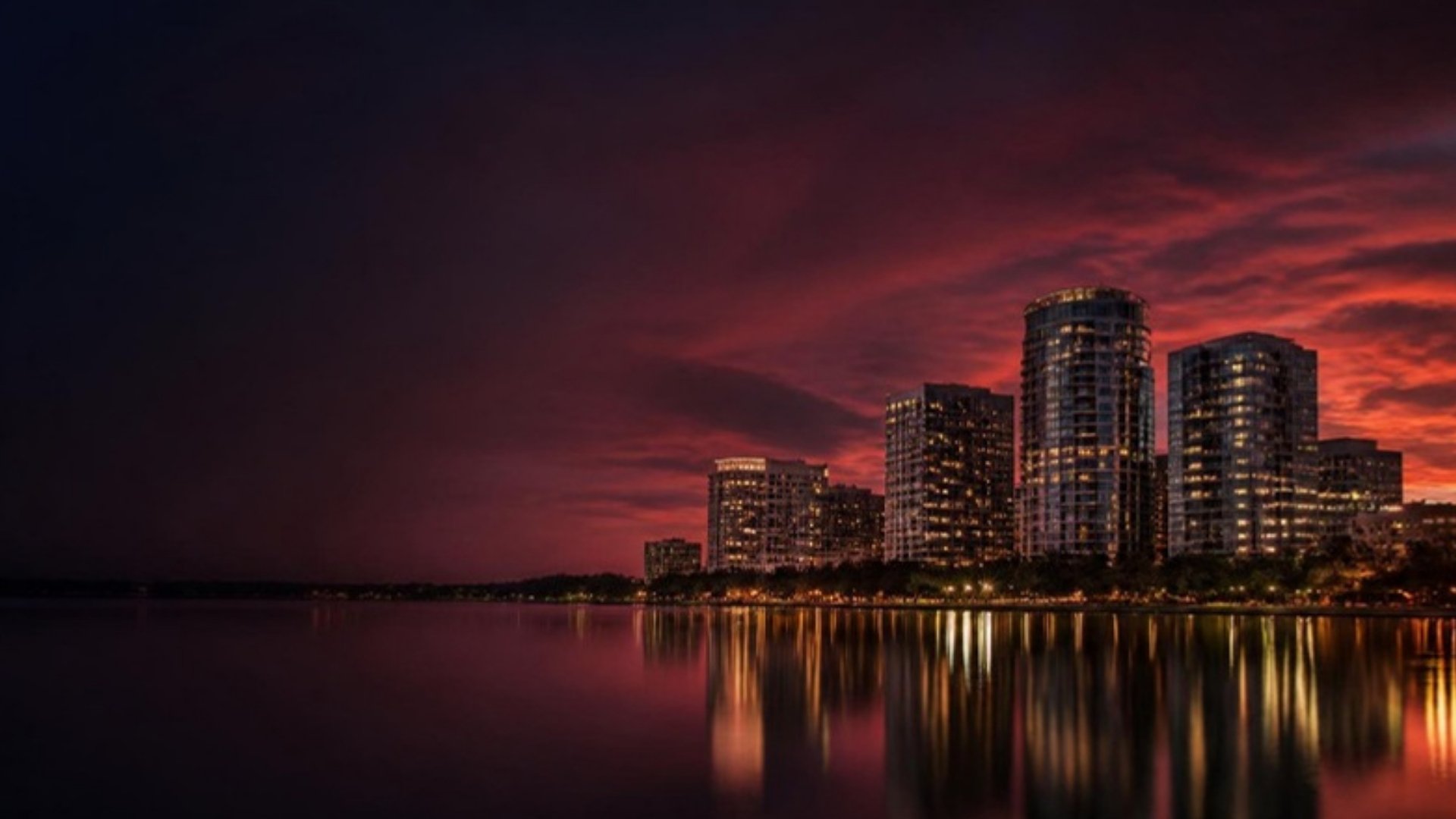 City skyline at dusk reflected in a lake
